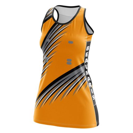Women's orange netball dress with black and grey sharp geometric streak patterns and side paneling for bulk B2B manufacturing.