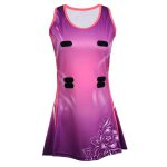 Women's netball dress featuring a purple and magenta gradient with a floral sublimation print and velcro attachments for bulk B2B manufacturing.