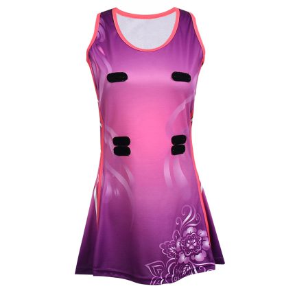 Women's netball dress featuring a purple and magenta gradient with a floral sublimation print and velcro attachments for bulk B2B manufacturing.