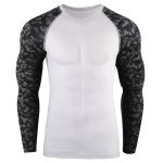 Men's long sleeve compression rash guard with a solid white body and black/grey geometric camo sublimated sleeves, designed for bulk manufacturing and private label fitness brands.